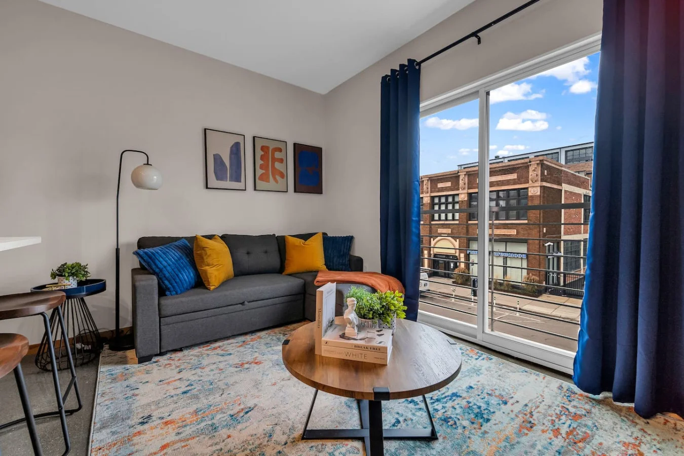 The living room’s plush seating beckons you to sink in and relax, surrounded by light and airy decor.