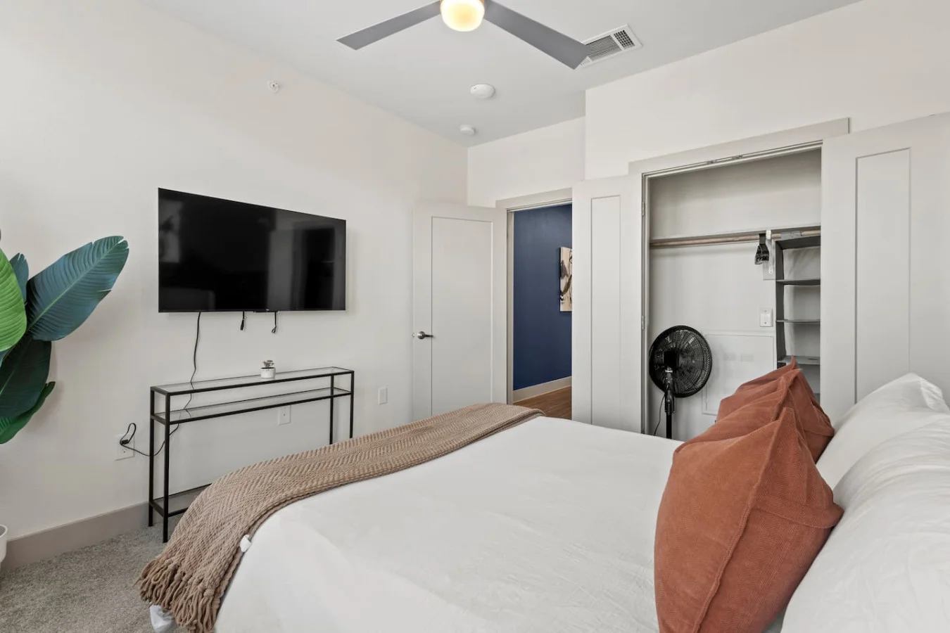 The bedroom offers a luxurious retreat, with a bed that promises restful nights and a room that feels like a private oasis.