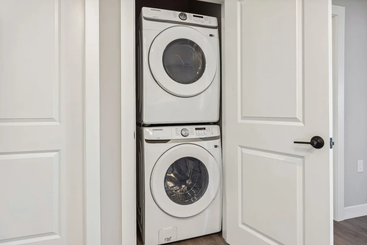 Laundry room with a washer, dryer, and folding area, offering all the convenience you need for a comfortable extended stay.