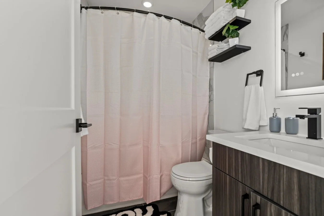 You feel a sense of calm as you enter the bathroom, where the thoughtful design and high-quality materials create a serene environment.