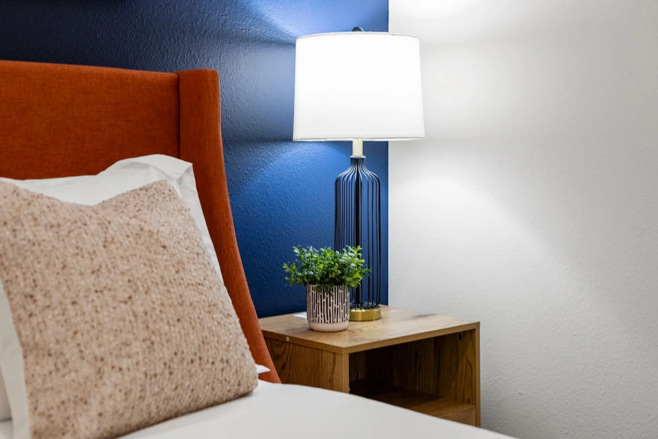 You feel enveloped in comfort as you relax on the queen bed, surrounded by a room designed for tranquility.