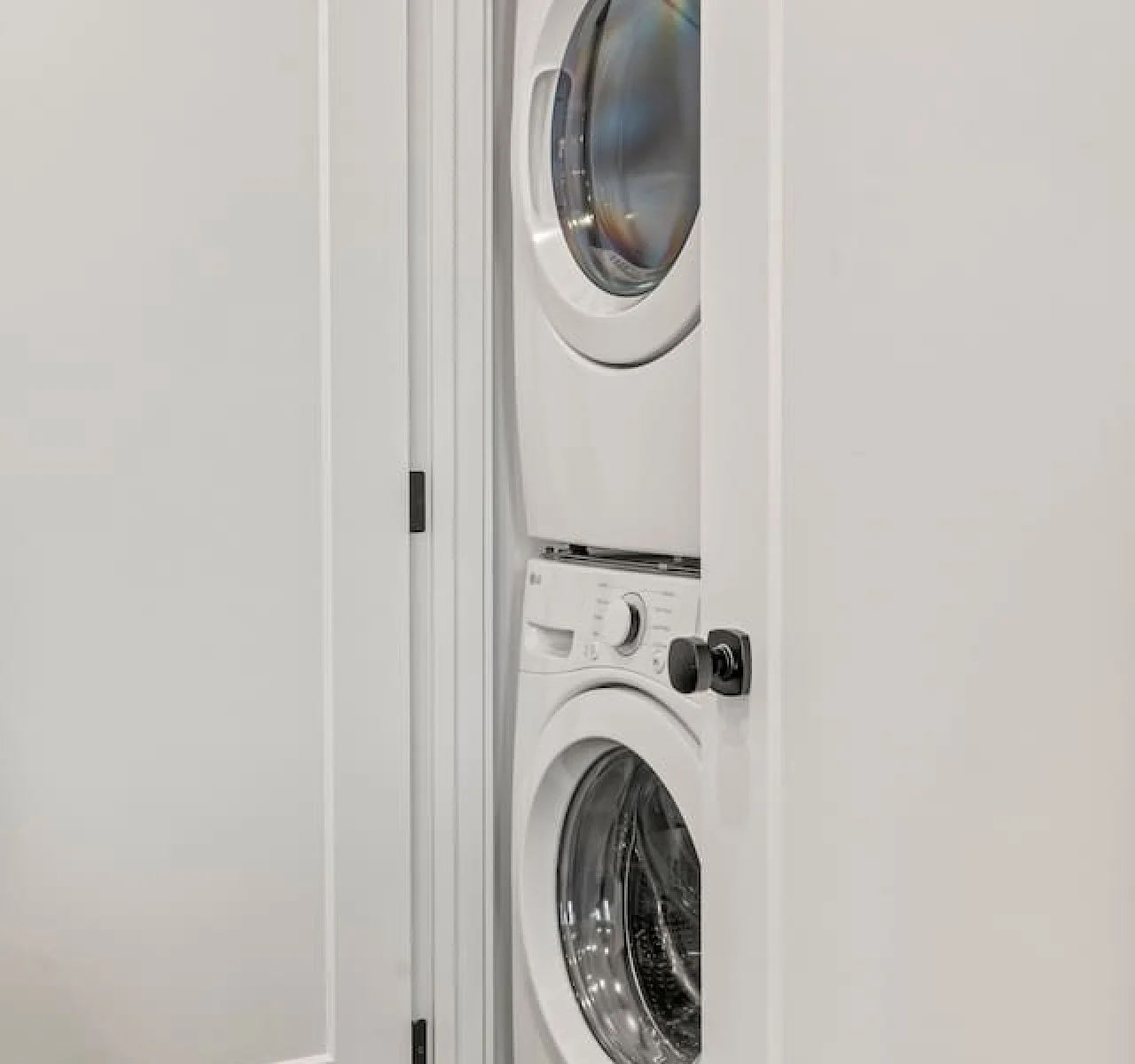 As you step into the laundry room, the modern appliances and ample storage space make it easy to keep things tidy.