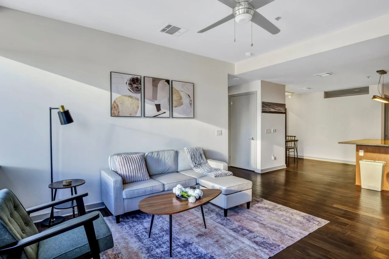 The living room’s cozy vibe makes it the perfect spot to relax, with ample seating and a warm ambiance.