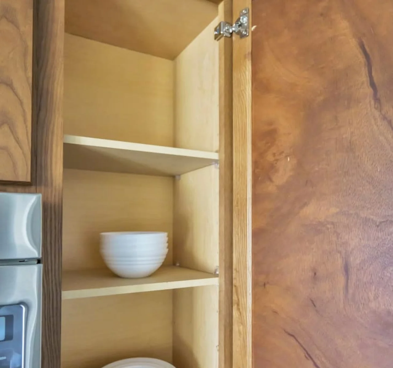 Kitchen cabinets stocked with cooking wares, glassware and silverwares, ideal for mixing up your favorite meals and drinks during your stay.