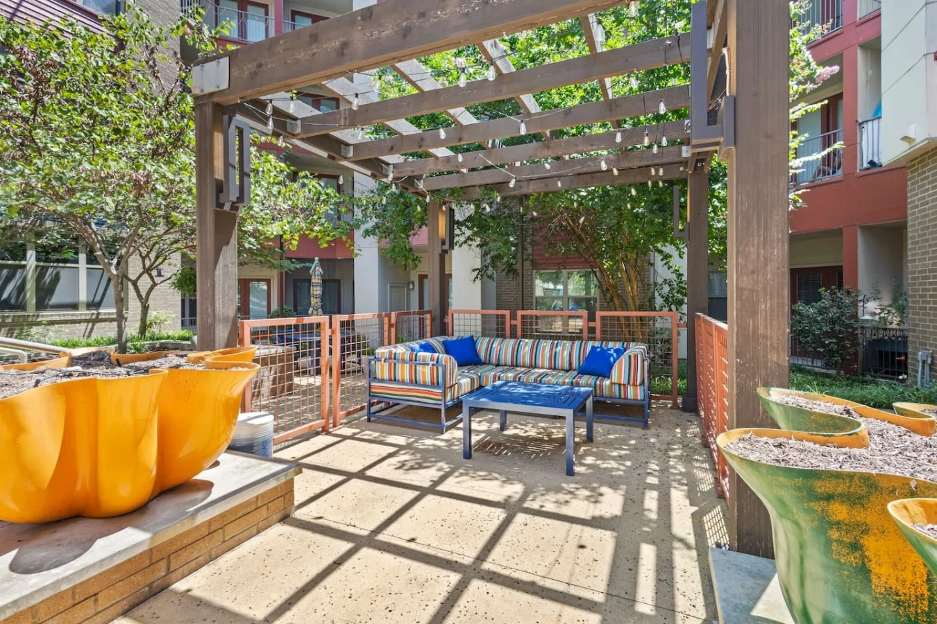 "Unwind under the pergola—your vibrant courtyard oasis for relaxation and conversation."