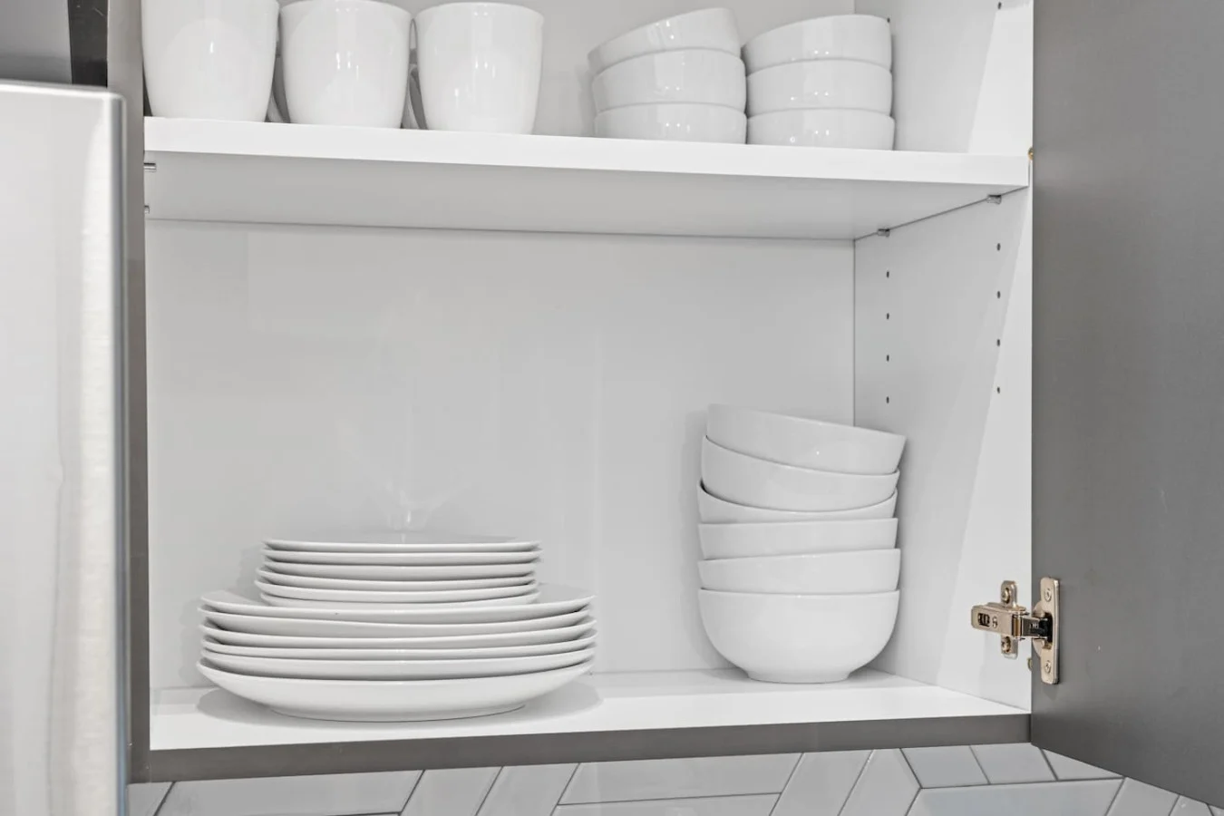 Kitchen cabinets stocked with cooking wares, glassware and silverwares, ideal for mixing up your favorite meals and drinks during your stay.