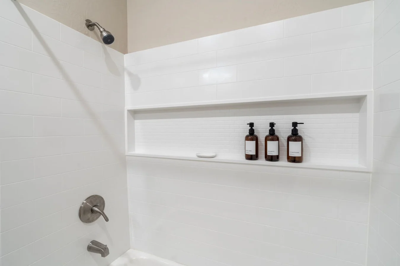 This bright and welcoming bathroom invites you to freshen up in comfort. Enjoy the forest-inspired shower curtain that adds a calming touch to your routine, complemented by the cozy rug underfoot and sparkling clean fixtures.