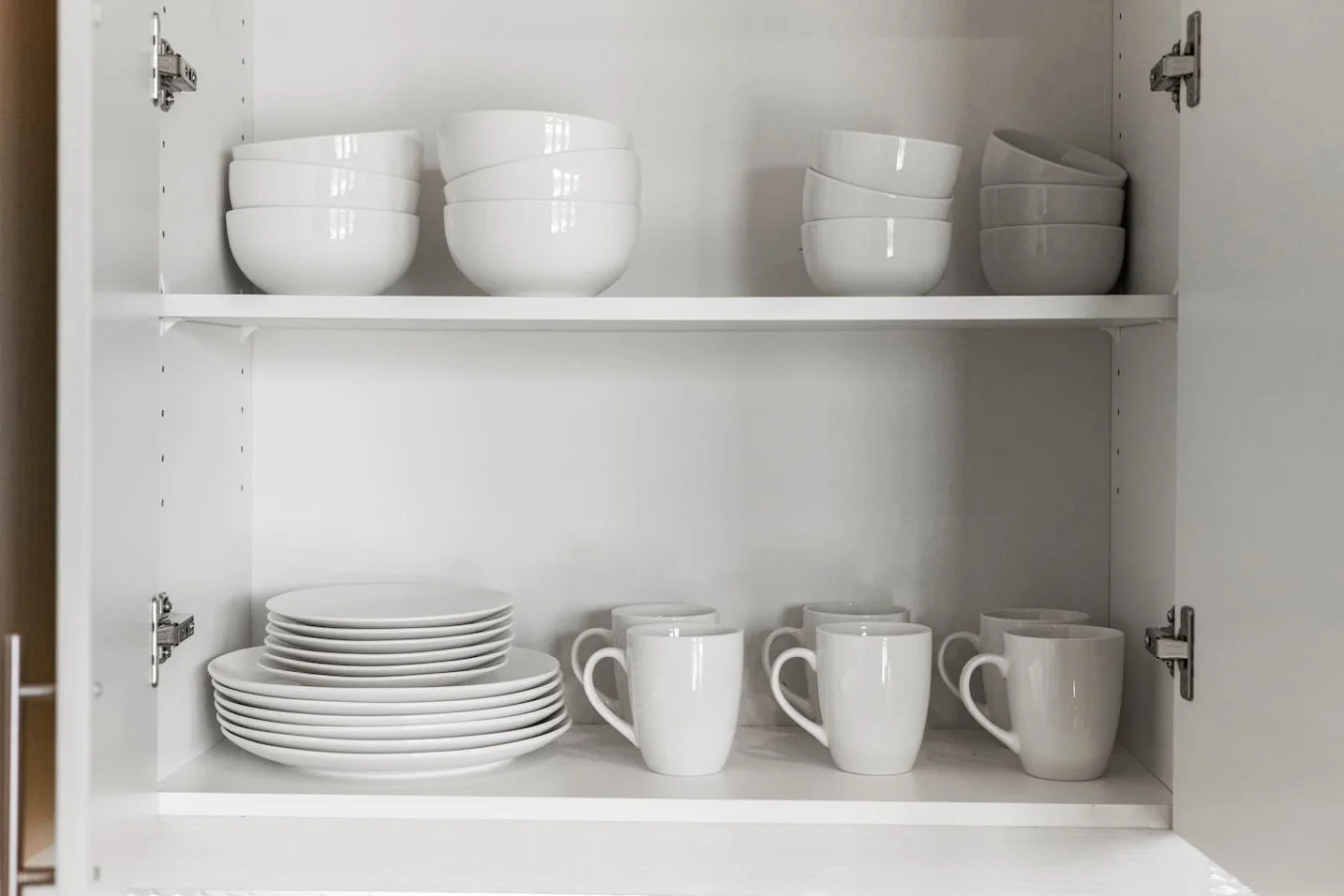 Kitchen cabinets stocked with cooking wares, glassware and silverwares, ideal for mixing up your favorite meals and drinks during your stay.