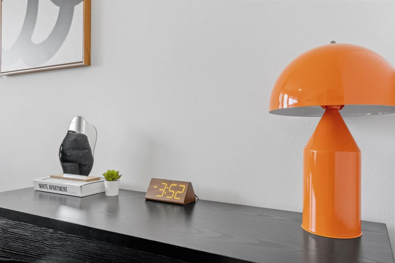 This cozy workspace with warm lighting, and a creative wall display, perfect for productivity.