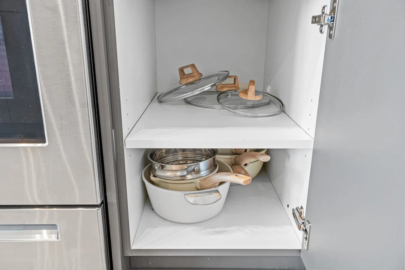 Kitchen cabinets stocked with cooking wares, glassware and silverwares, ideal for mixing up your favorite meals and drinks during your stay.
