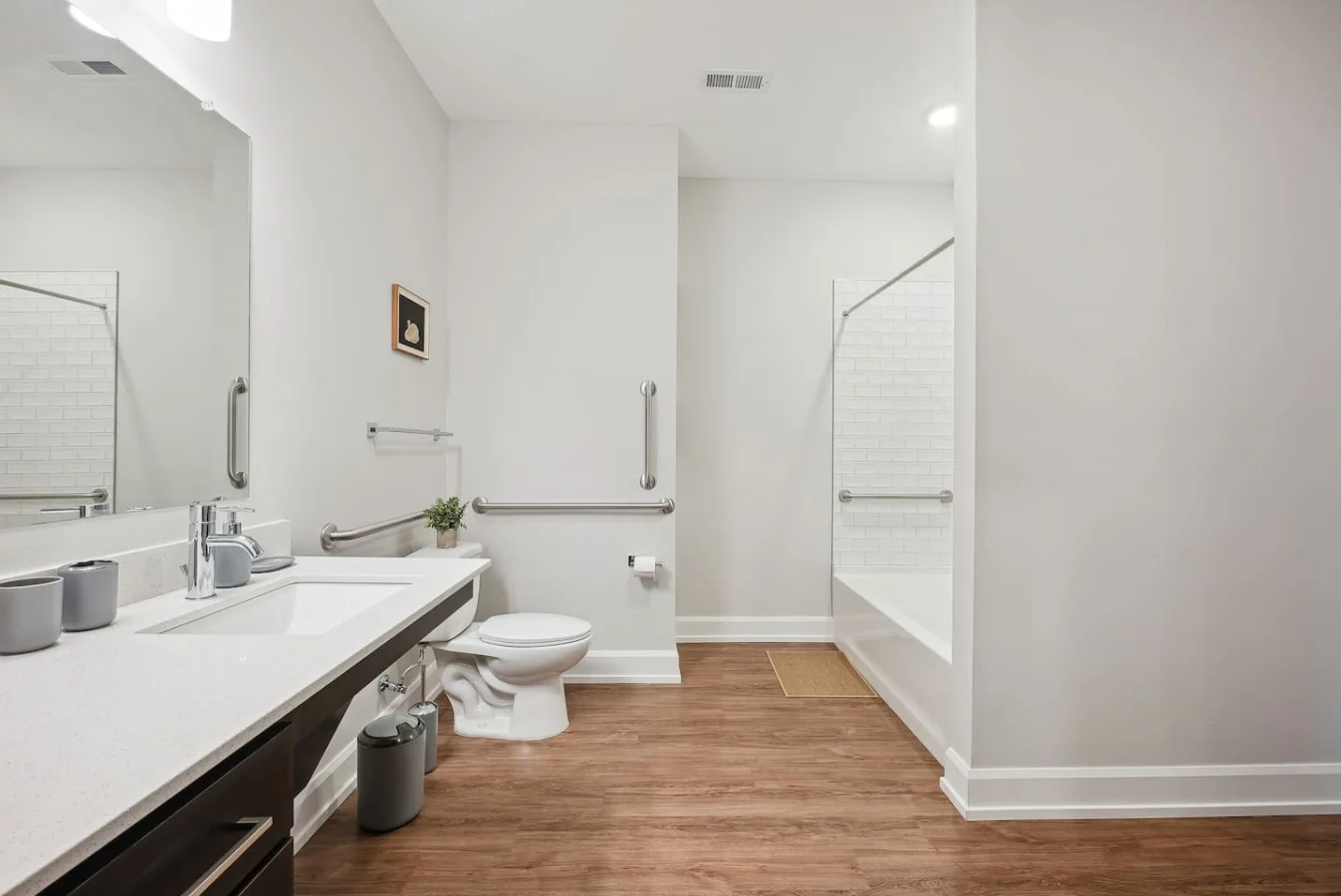Sleek and clean bathroom vanity with modern fixtures, lush greenery, and premium hand soap. Refresh and unwind in style.