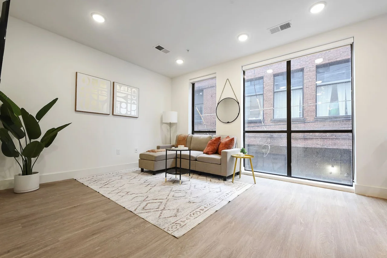 Relax in this warm, inviting space with wooden accents and cozy furnishings. You’ll love unwinding on the plush sofa, enjoying a good book or streaming your favorite shows in a serene atmosphere