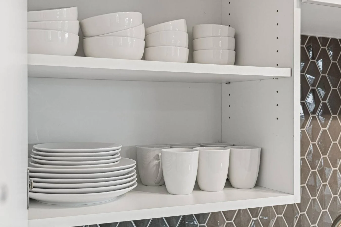 Kitchen cabinets stocked with cooking wares, glassware and silverwares, ideal for mixing up your favorite meals and drinks during your stay.