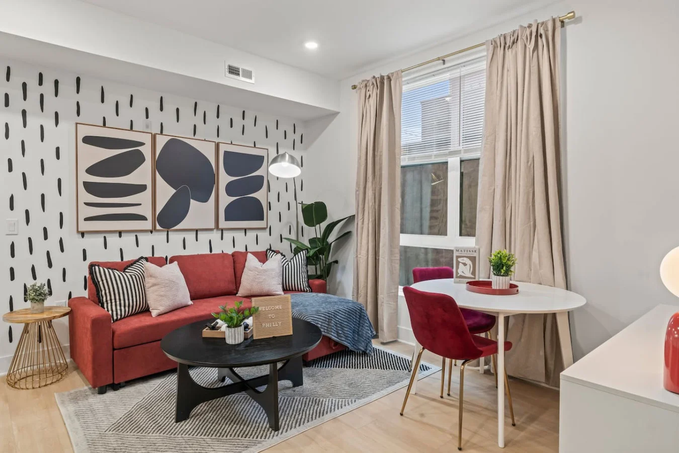 Living Room with Pull Out Sofa Bed, Coffee Table, Dining Table, 55" TV, Overhanging Reading Light