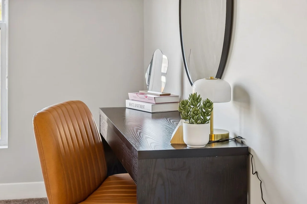 This cozy workspace with warm lighting, and a creative wall display, perfect for productivity.