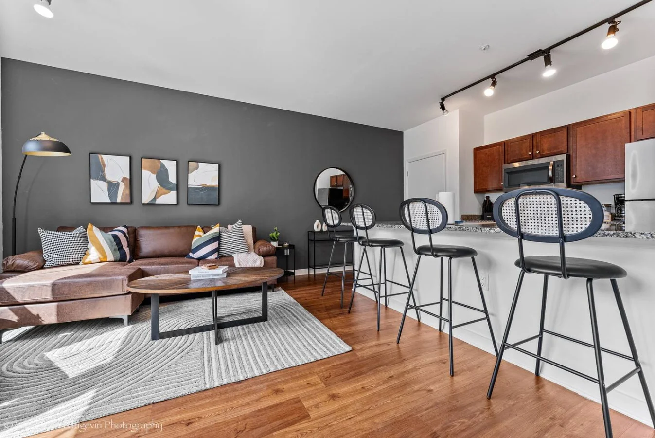 Spacious open-concept living and dining area featuring a vibrant sofa, modern furnishings, and a stylish entertainment setup—ideal for gatherings and relaxation.