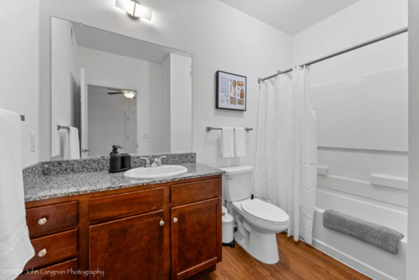 Sleek and clean bathroom vanity with modern fixtures, lush greenery, and premium hand soap. Refresh and unwind in style.