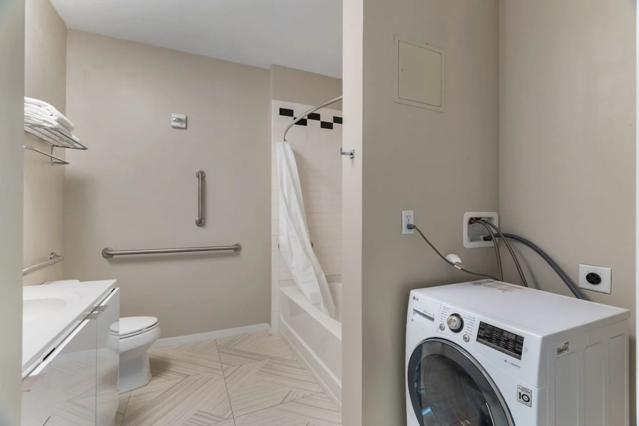 As you step into the laundry room, the modern appliances and ample storage space make it easy to keep things tidy.