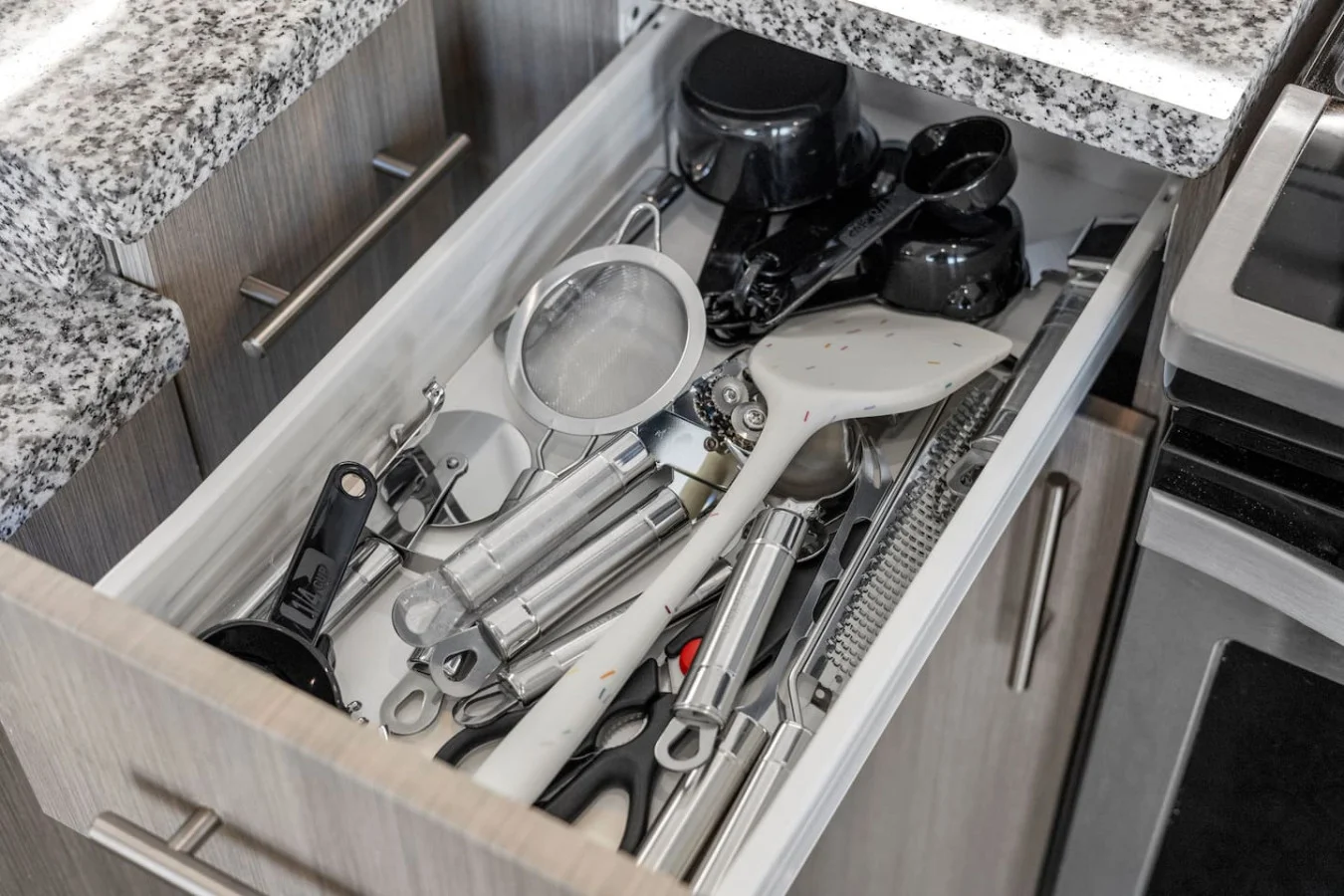 Kitchen utensils with scissors, measuring cups, grater, wine opener, can opener