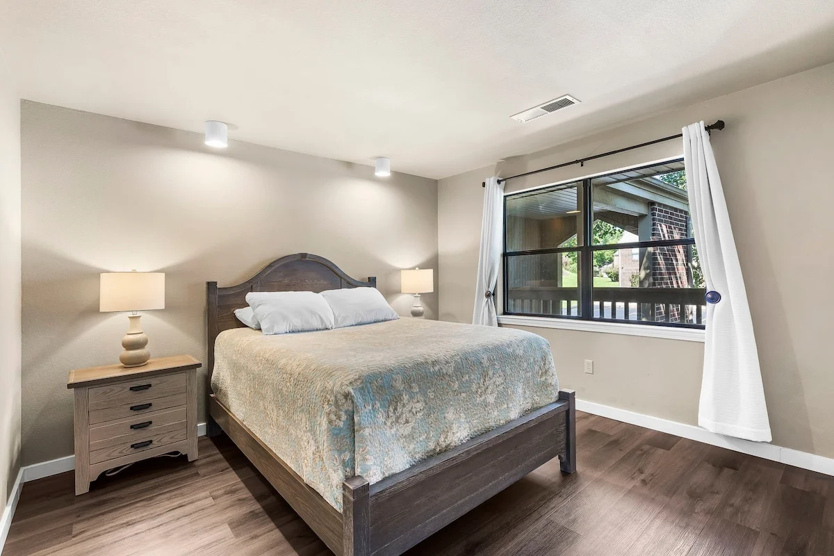 Downstairs guest bedroom queen-size bed.