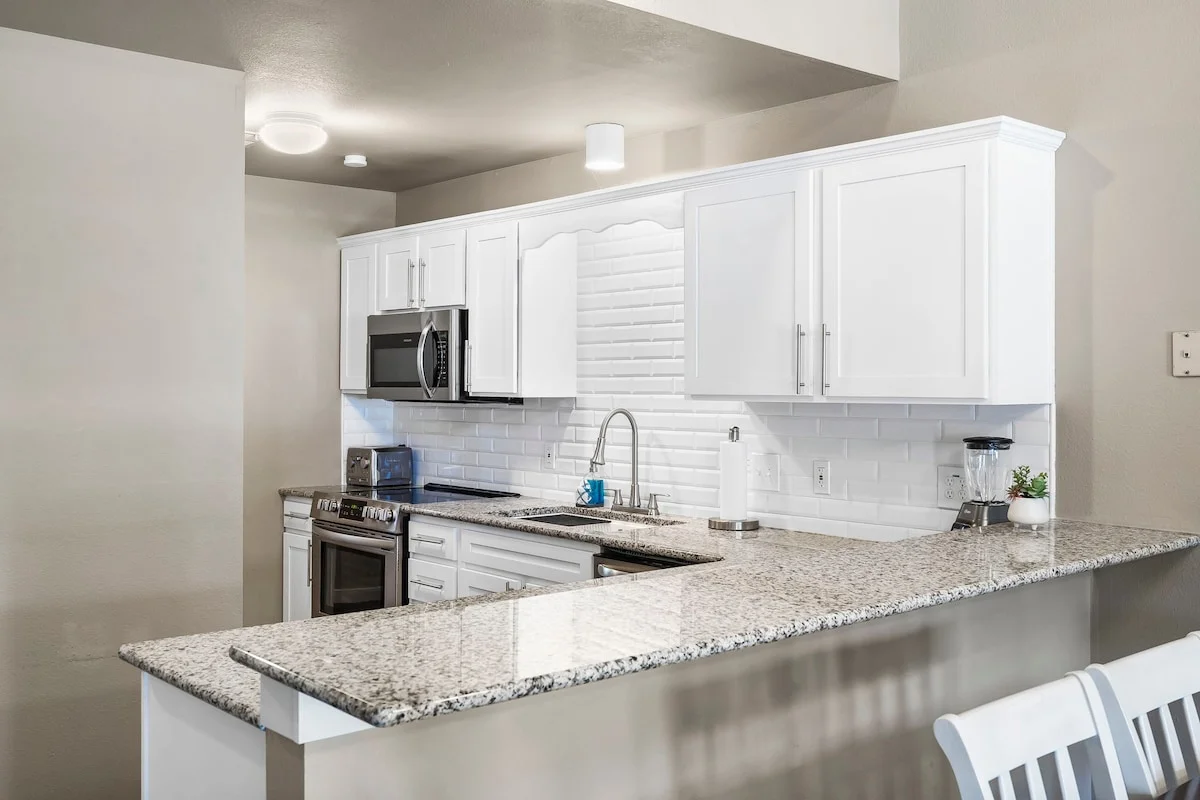 Kitchen with fully stocked cooking utensils and coffee bar.