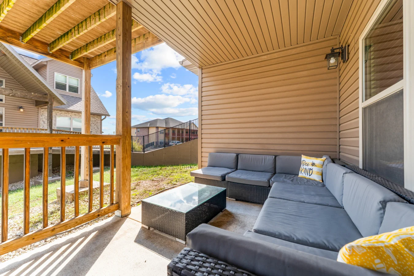 Spacious covered patio featuring a big cozy couch for lounging and unwinding.