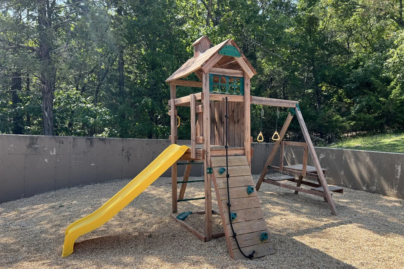 Let the kids explore the community playset while the adults relax nearby. A great spot for outdoor fun and family memories.