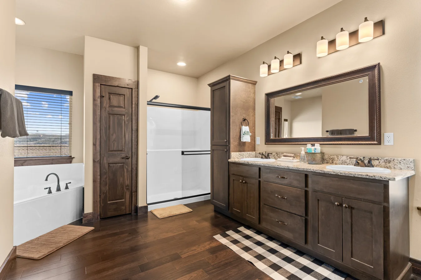 Your private lakeside spa. Unwind in the oversized jetted tub or enjoy a refresh in the walk-in shower. This massive bathroom also features a private water closet for added comfort and seclusion