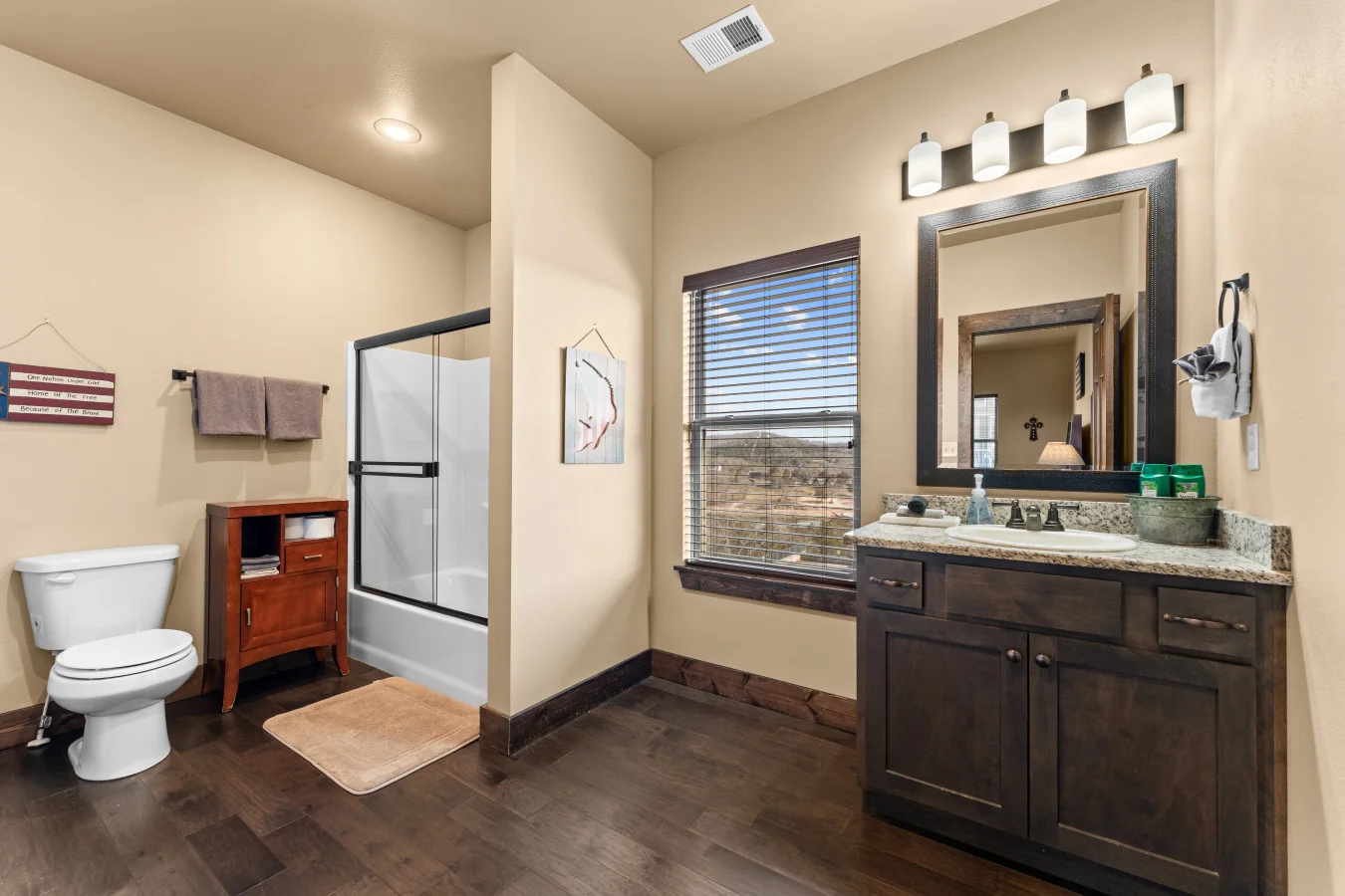 Modern, clean, and completely private. Attached directly to rocking chair king bedroom, this full bathroom with tub and shower combo provides the perfect secluded spot to prepare for a day of Branson adventures.
