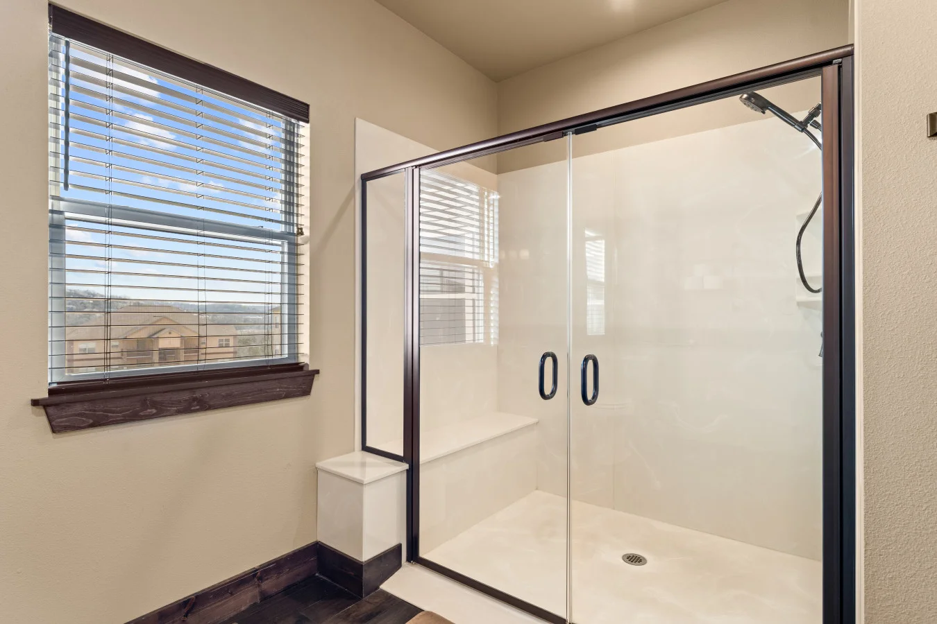Enjoy the ultimate convenience of this private master ensuite. Designed with accessibility in mind, it features a ramp-entry shower with double doors and sturdy grab bars