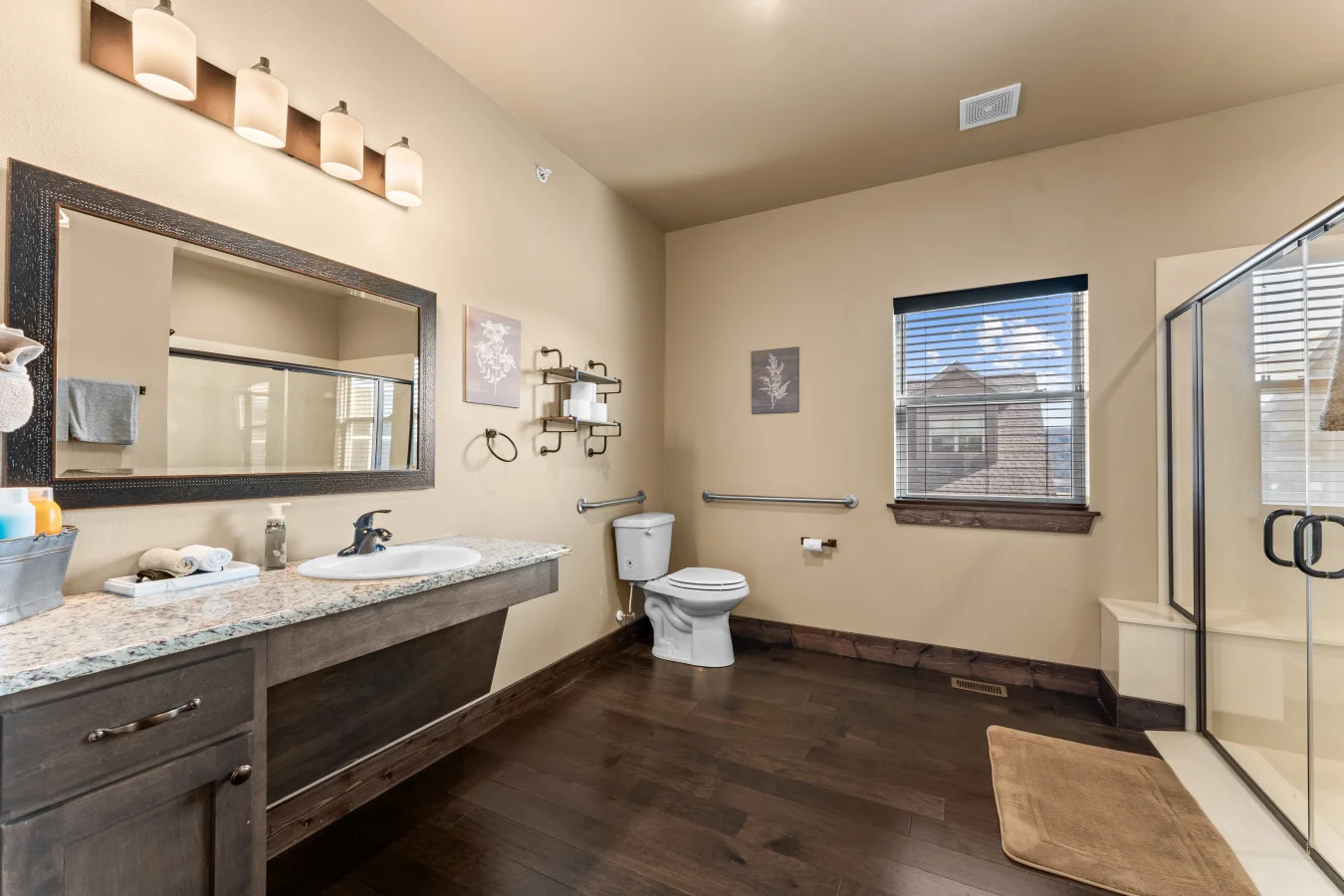 Enjoy the ultimate convenience of this private master ensuite. Designed with accessibility in mind, it features a ramp-entry shower with double doors and sturdy grab bars