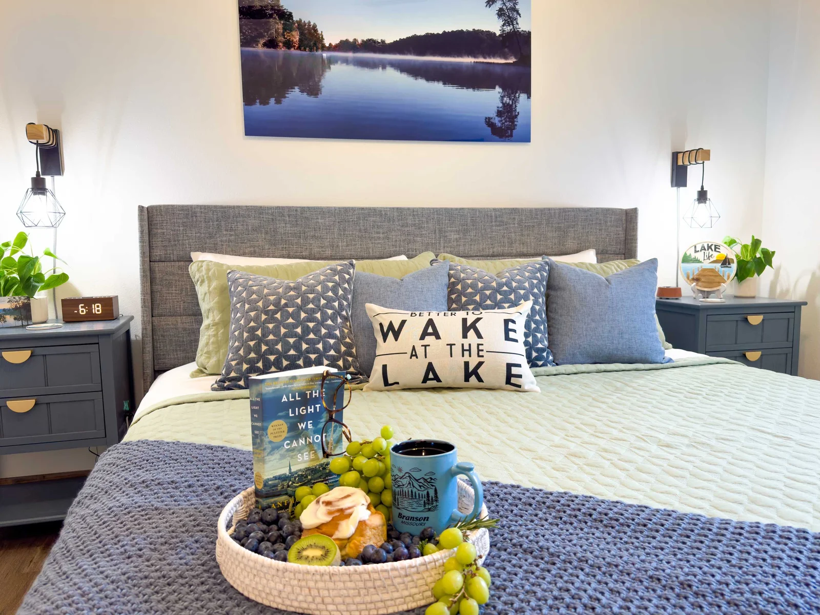 Soft sage green and light blue tones are layered throughout the bedding and decor, creating a breezy, tranquil ambiance perfect for rest and relaxation.