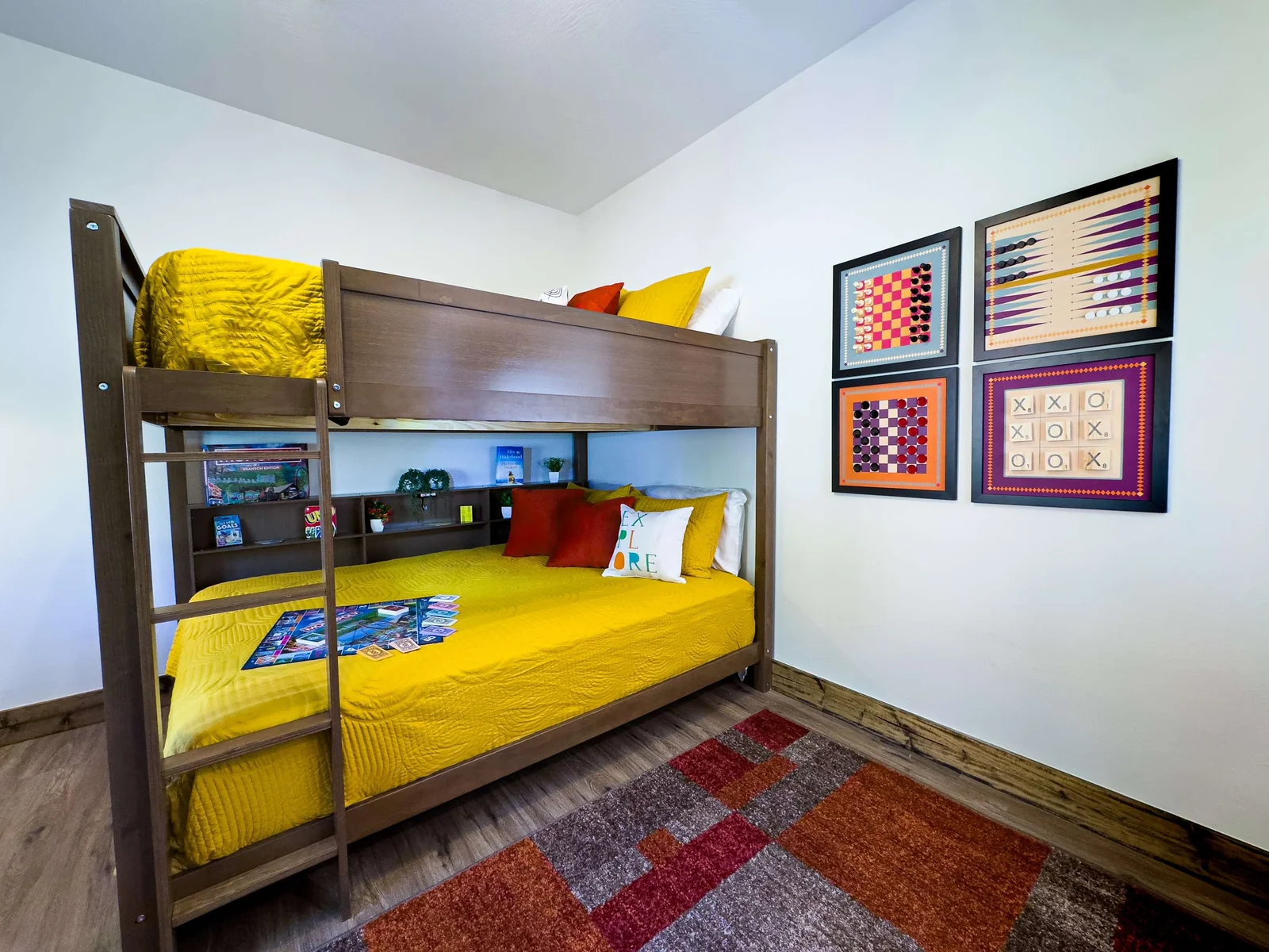 Featuring queen-over-queen bunks dressed in cheerful bedding, this space radiates energy and playfulness.