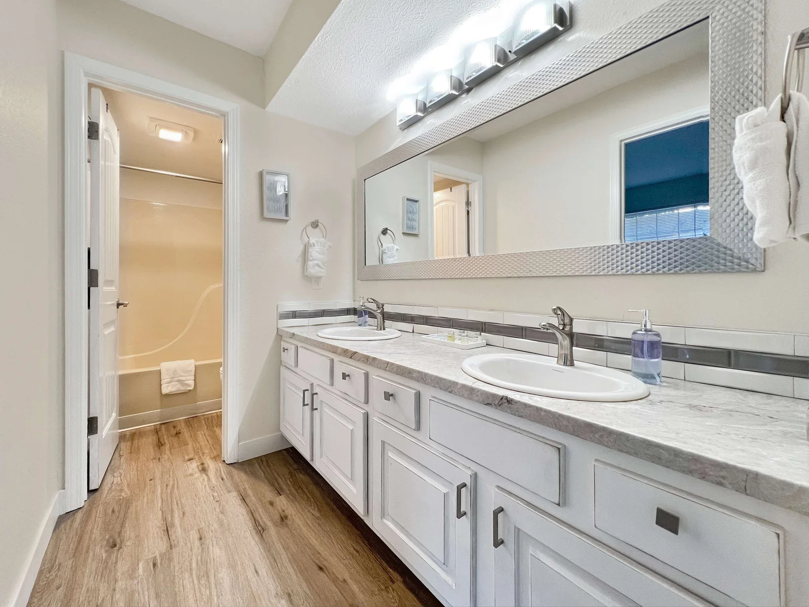 Dual vanity bathroom with tub and shower