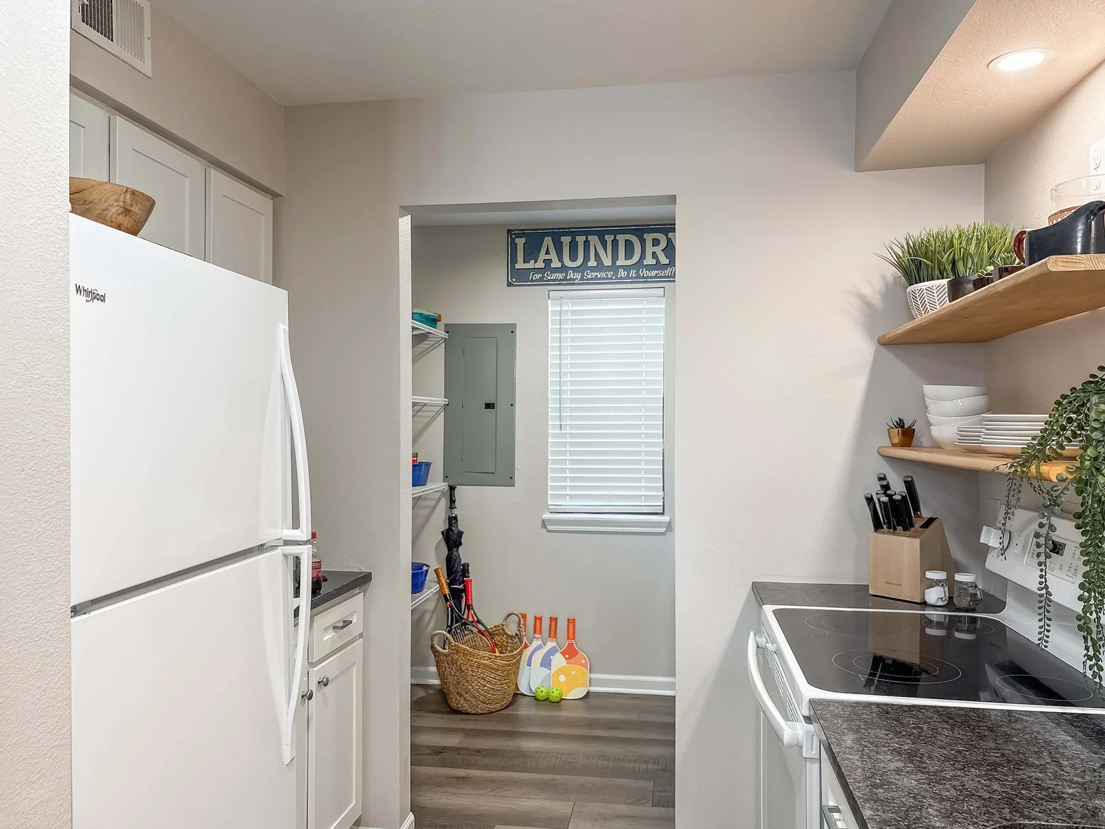 At the back of the kitchen is the laundry with a washer and dryer.