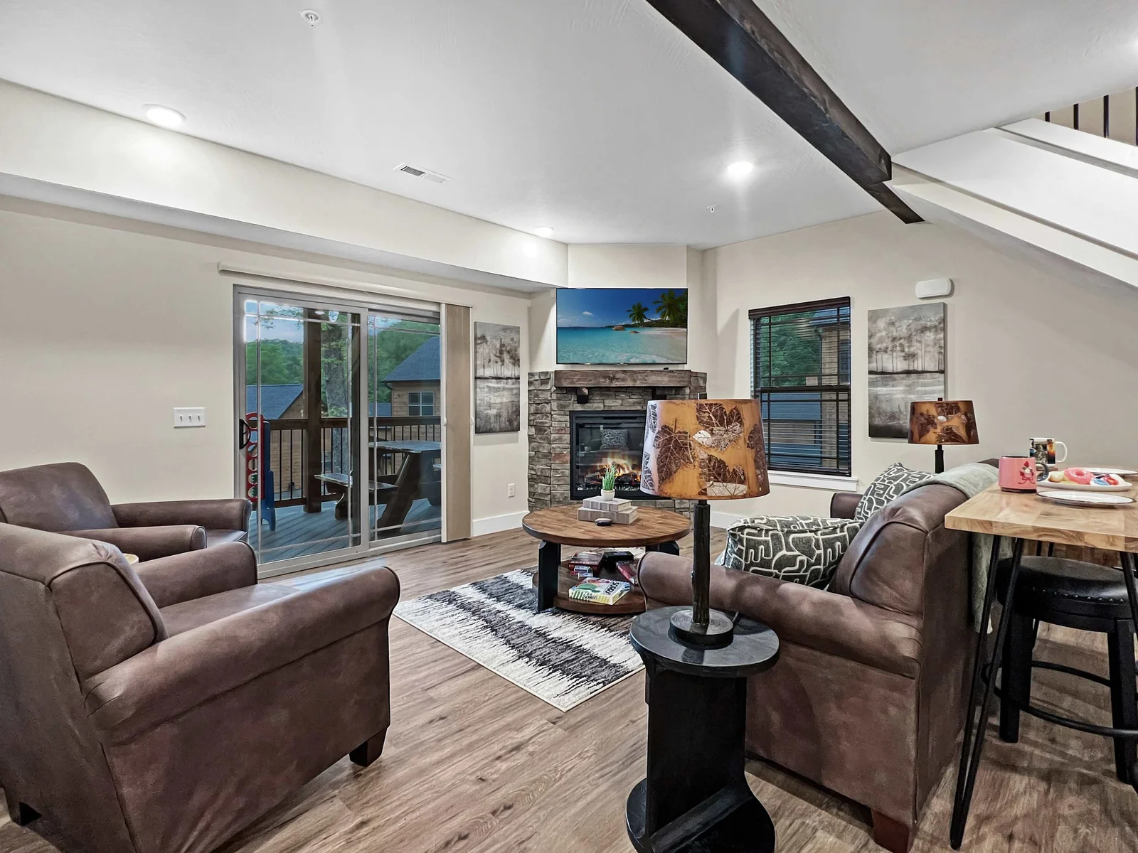 A living room to die for! Gorgeous rock fireplace, natural wood beams, luxury leather furnishings, smart tv(bring your streaming passwords), walk out onto beautiful deck and even play board games for the provided by the host for your family to enjoy