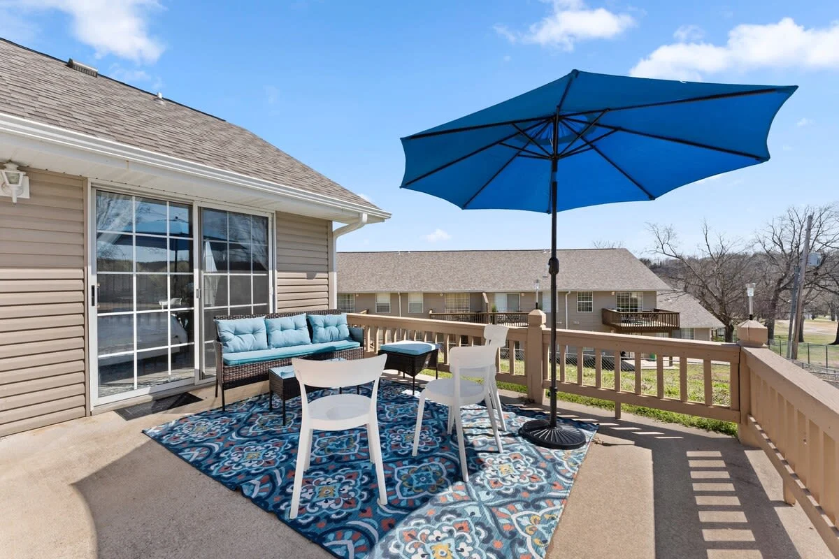 Sitting area outside the master bedroom with seating and umbrella