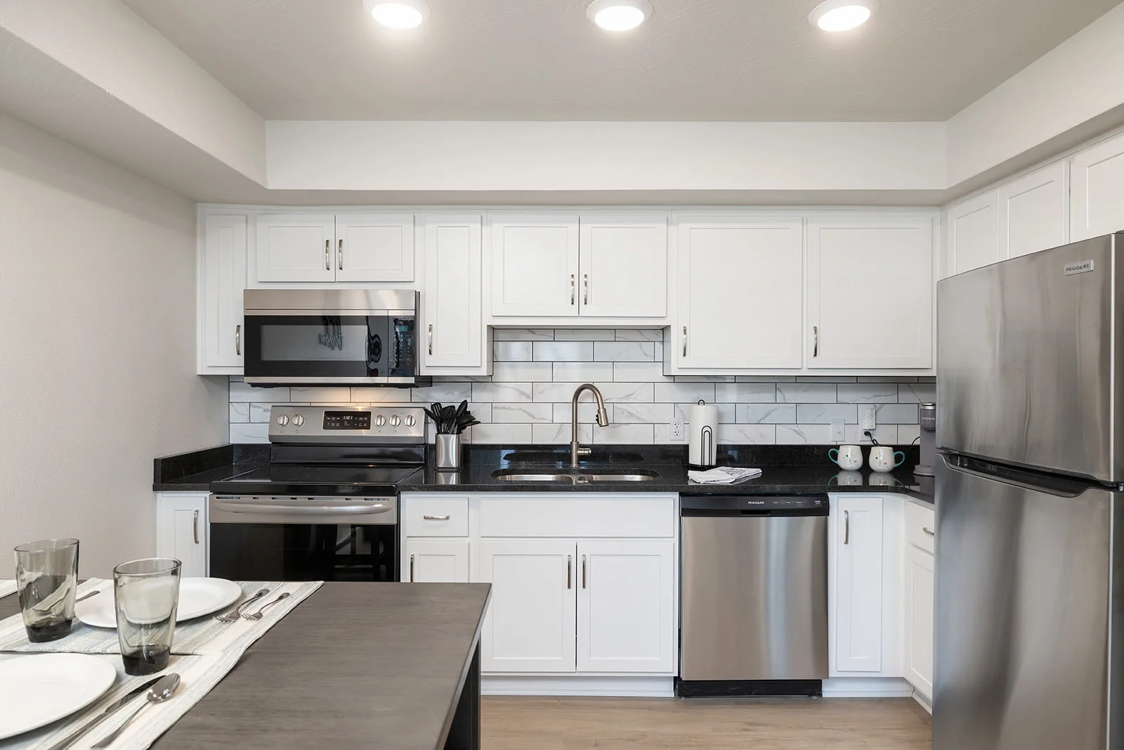 Beautiful dining room and kitchen with custom tile backsplash