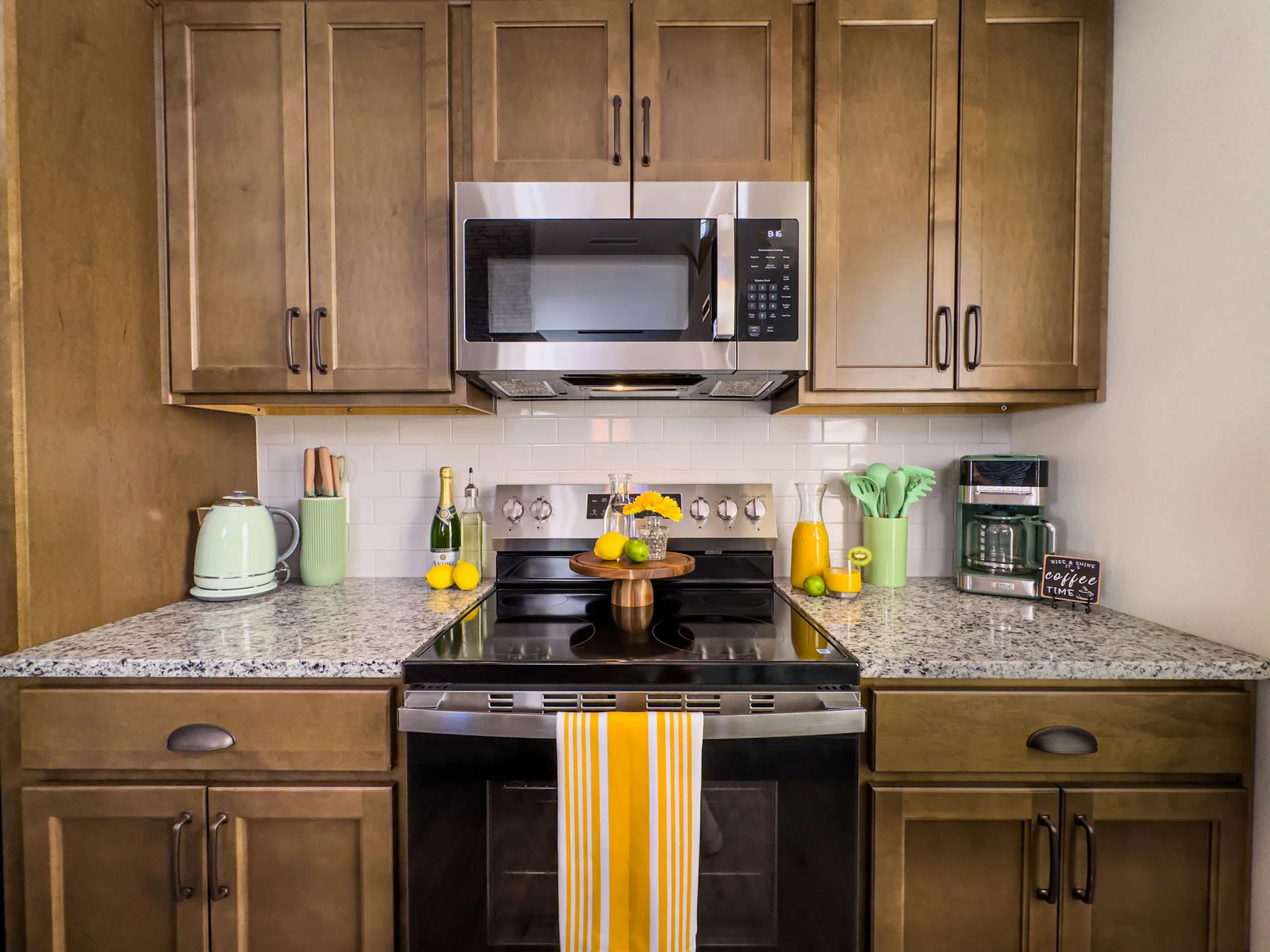 The kitchen features gleaming granite countertops, high-end stainless steel appliances, and all the cookware and gadgets you need to craft meals for your family and friends.