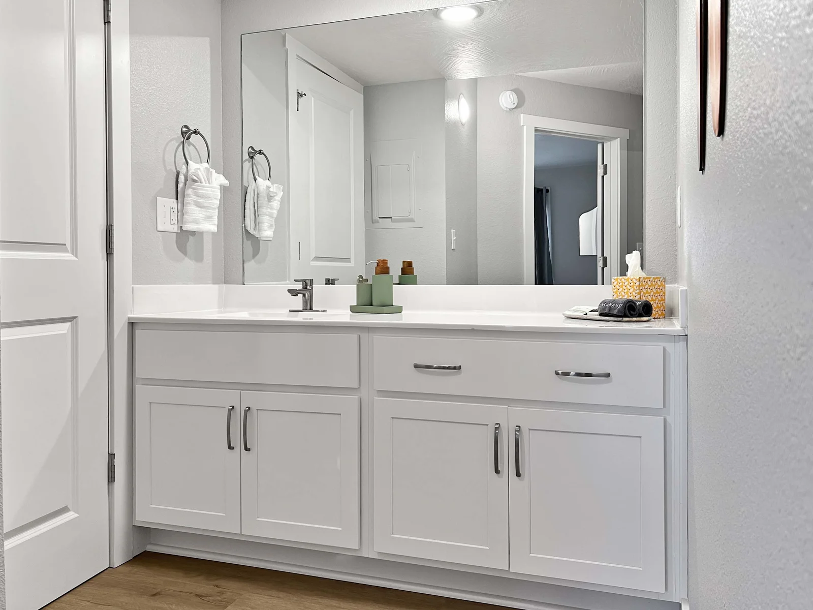 Perfect bathroom with hughe mirror and toilet and tub/shower with a privacy door.