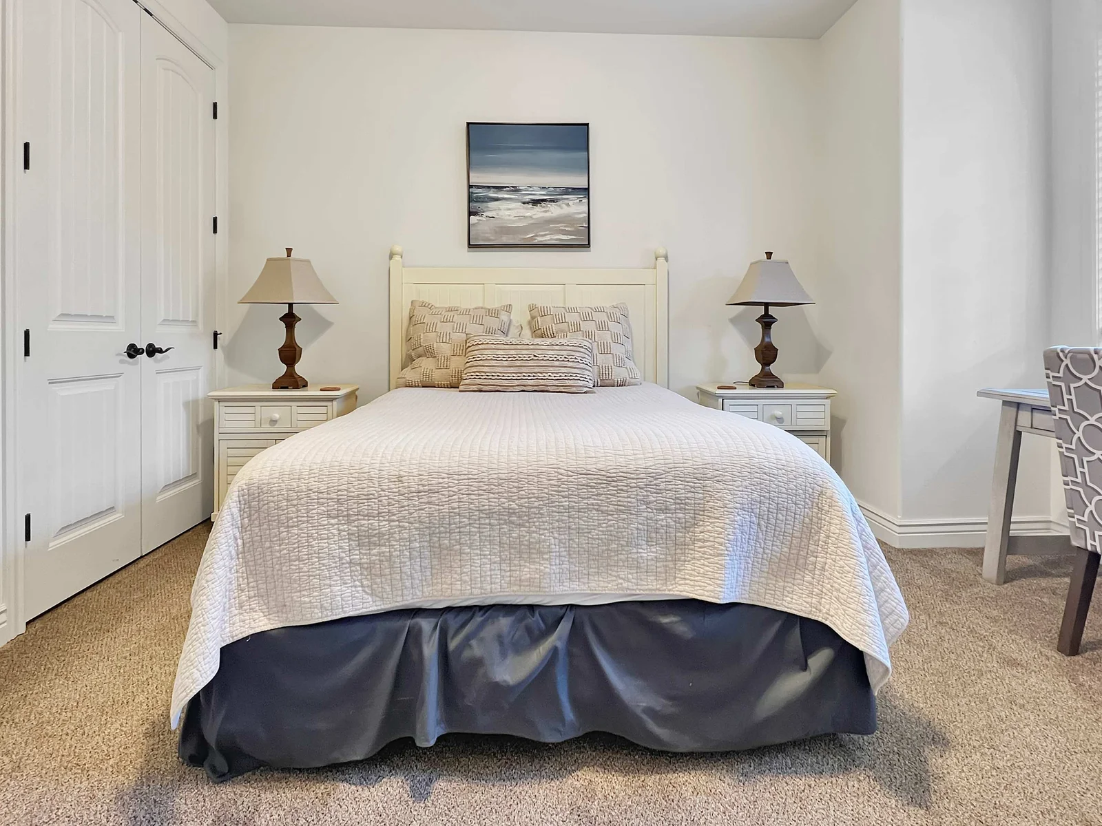 Spacious bedroom complete with desk and chair.
