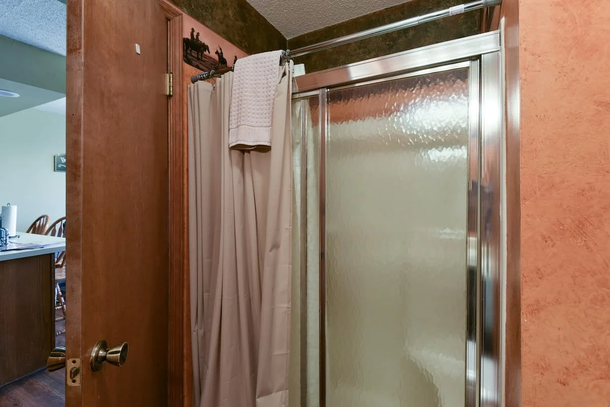 Main bathroom - Step in shower with a small built in seat.