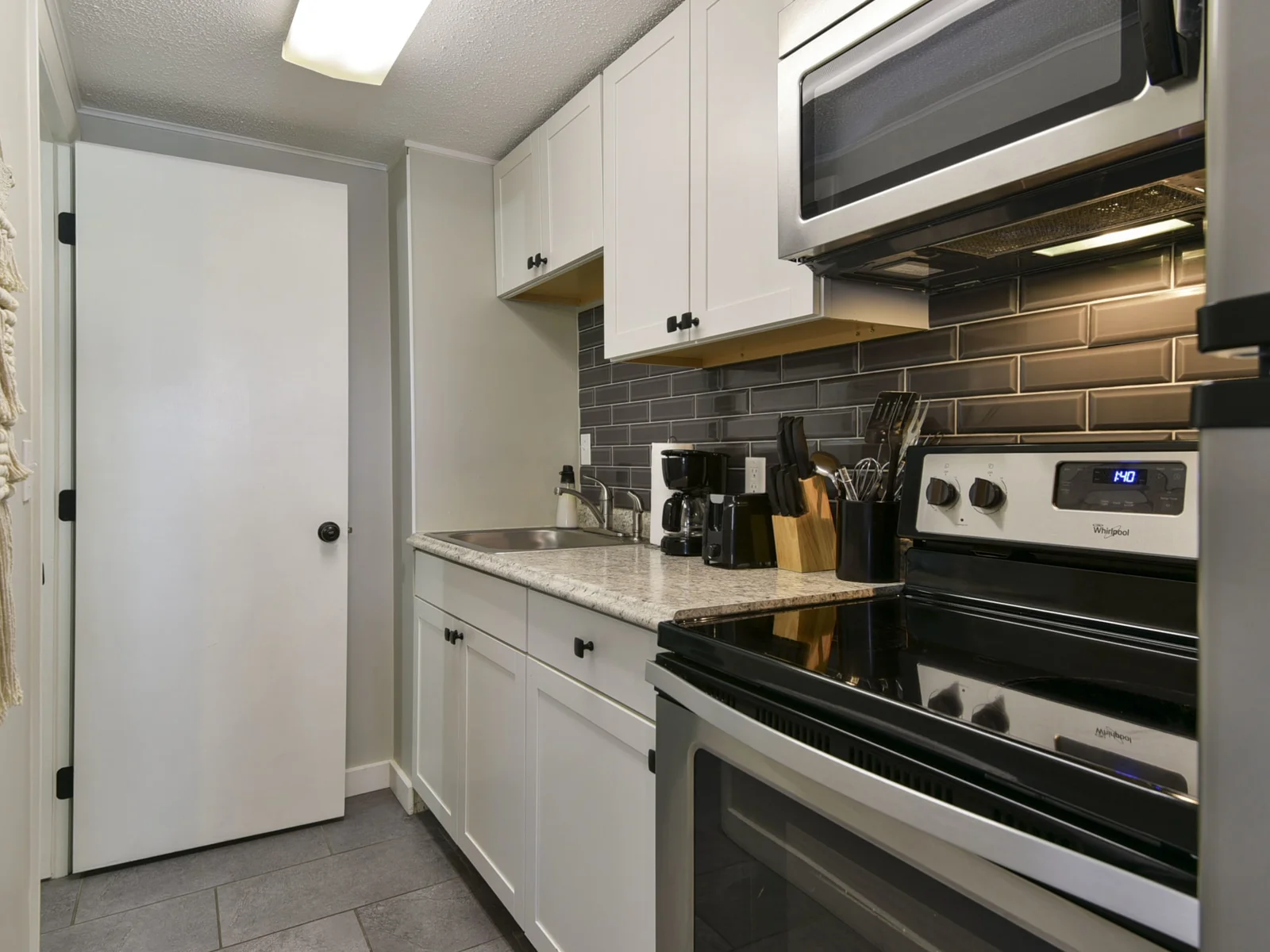 Kitchen with a view of the doorway to the bathroom