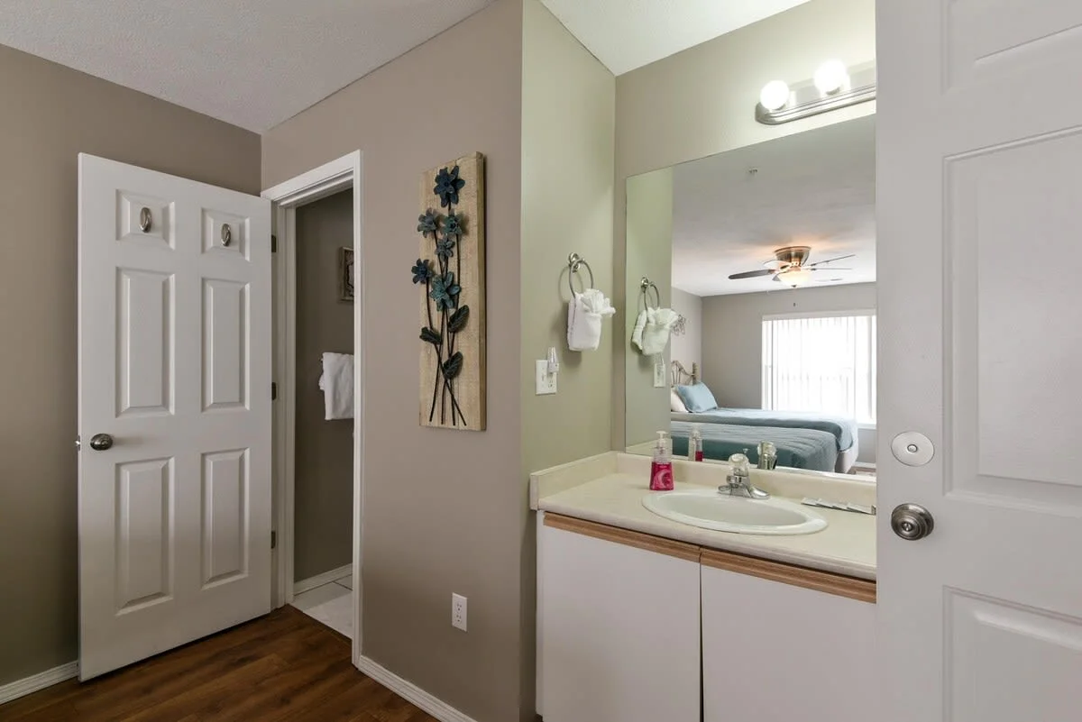 Vanity and attached bathroom in double Queen room.