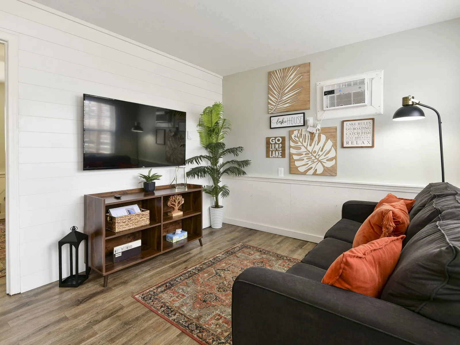 Living room with wall AC unit and Roku TV