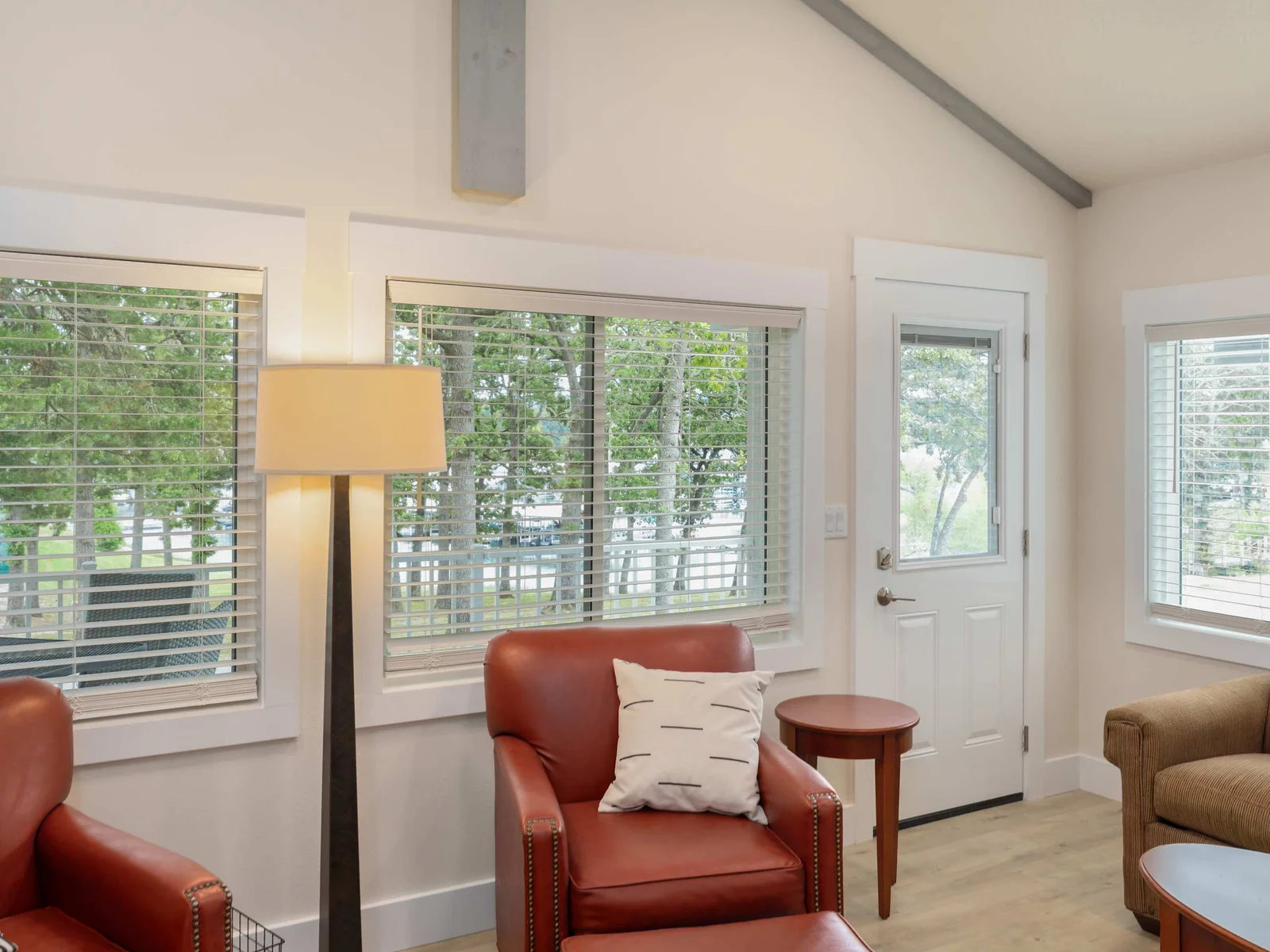 Living room with door to back patio. Lake view and calming nature noises on a cool morning are unbeatable.