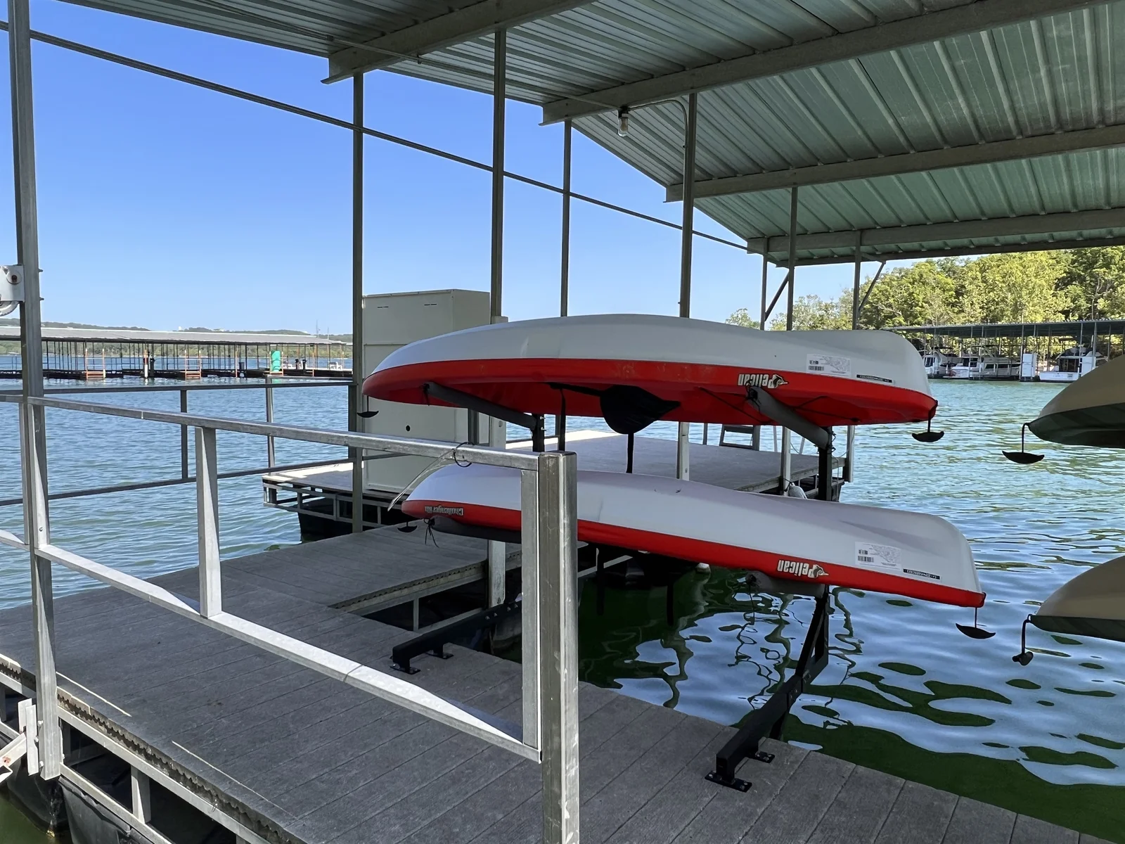 4 kayaks and 1 paddle board with life jackets and paddles
