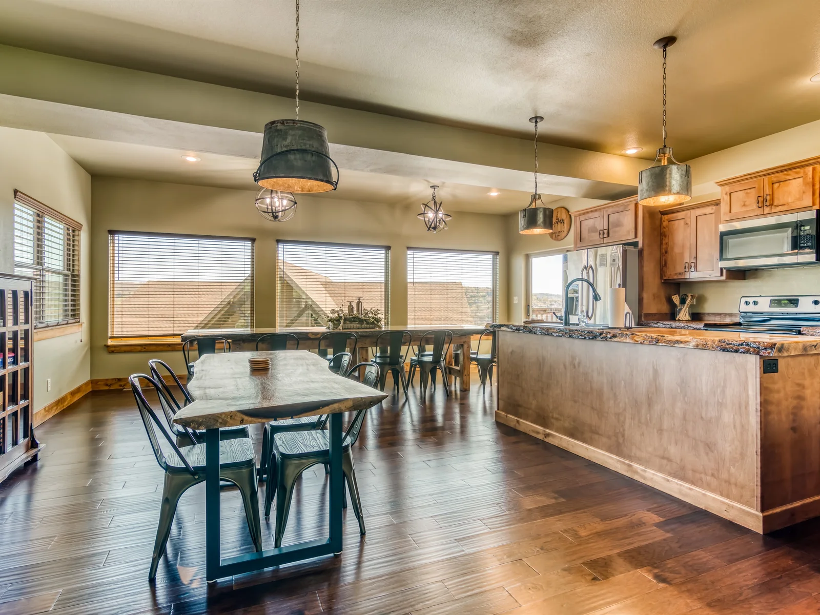 Open kitchen with lots of seating around the handmade live edge tables