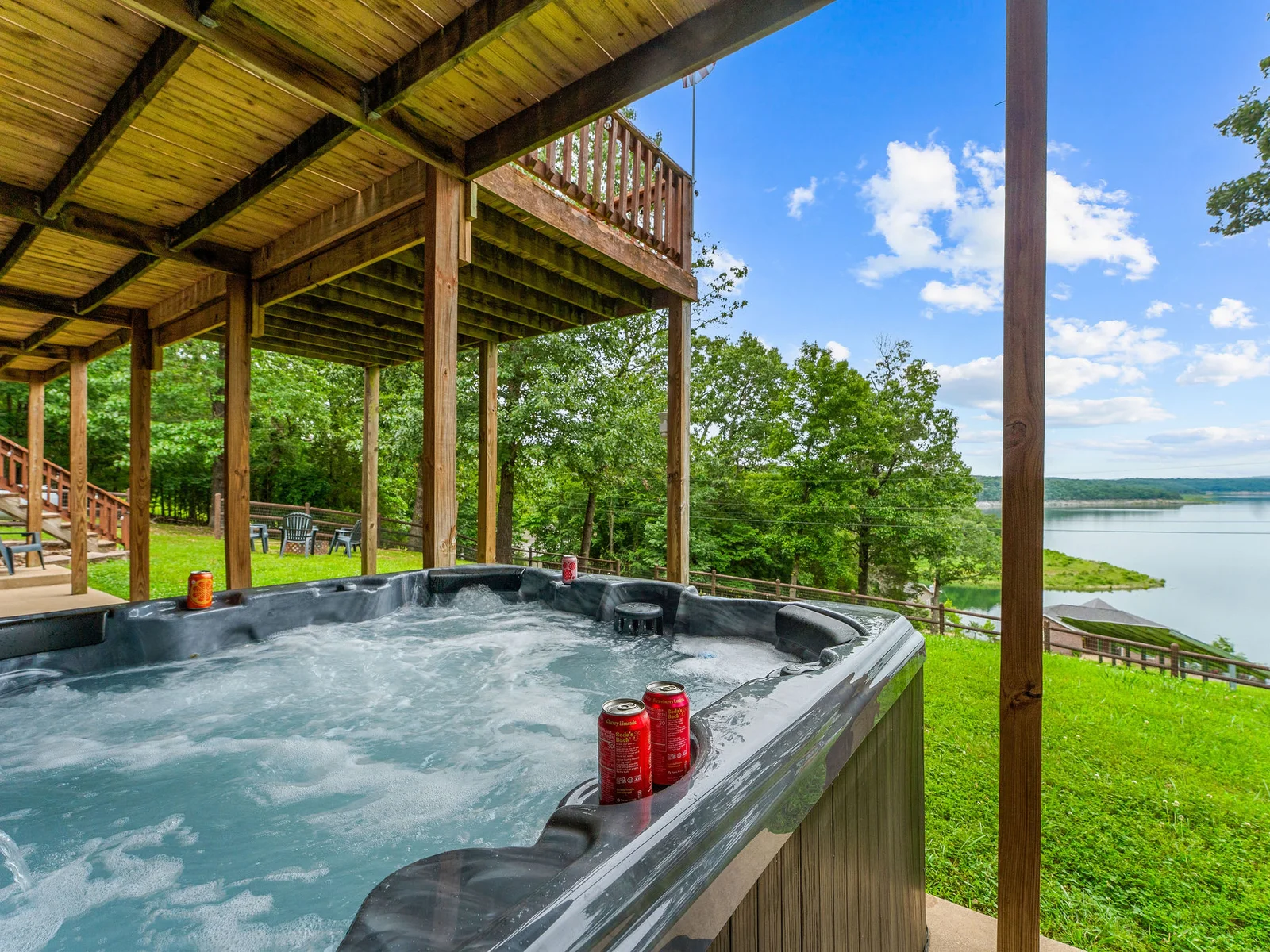 Jets running, deck above you lit with string lights, Bull Shoals Lake glimmering behind the trees — the hot tub at dusk is where the best conversations happen.