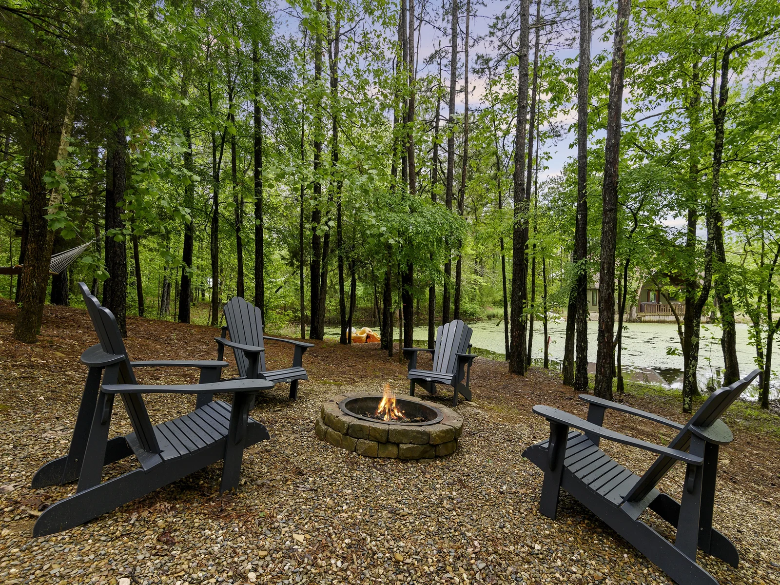 Fireside serenity with a view: Where flames dance as the pond mirrors the starry sky